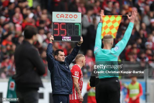 Substitution board displaying the message 'Stop Racism' in support of the International week against racism during the Bundesliga match between...