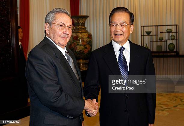 Cuban President Raul Castro shakes hand with Chinese Premier Wen Jiabao during a meeting held at the Zhongnanhai diplomatic compound on July 6, 2012...