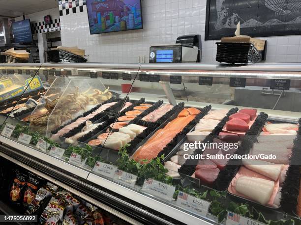 Variety of wild-caught and farm-raised seafood, organic chicken, and marinated meats displayed in a retail counter at Diablo Foods, with options for...