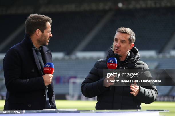 Pundit Gary Neville speaks to Jamie Redknapp prior to the Premier League match between Newcastle United and Manchester United at St. James Park on...