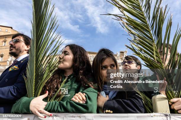 Faithful attend the Palm Sunday Mass presided by Pope Francis at St. Peter's Square on April 02, 2023 in Vatican City, Vatican. The 86-year-old...