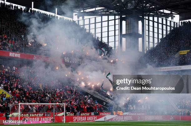 General view inside the stadium as fans let off flares during the Bundesliga match between 1. FC Köln and Borussia Mönchengladbach at...