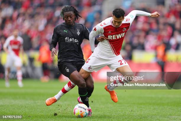 Kouadio Kone of Borussia Moenchengladbach tackles Davie Selke of 1.FC Koeln during the Bundesliga match between 1. FC Köln and Borussia...