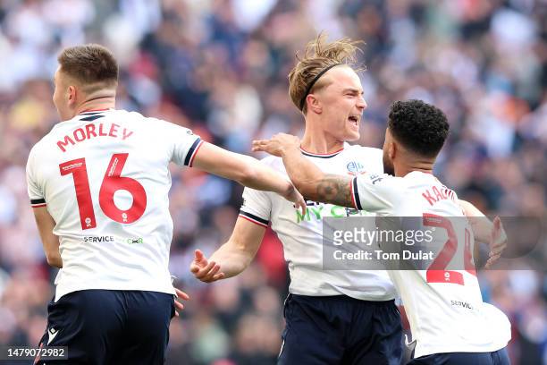 Kyle Dempsey of Bolton Wanderers celebrates with teammates Aaron Morley and Elias Kachunga after scoring the team's first goal during the Papa John's...