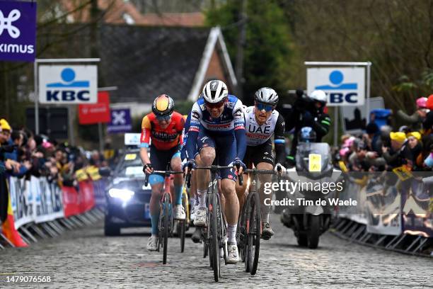 Kasper Asgreen of Denmark and Team Soudal Quick-Step and Matteo Trentin of Italy and UAE Team Emirates compete at Kwaremont cobblestones sector...