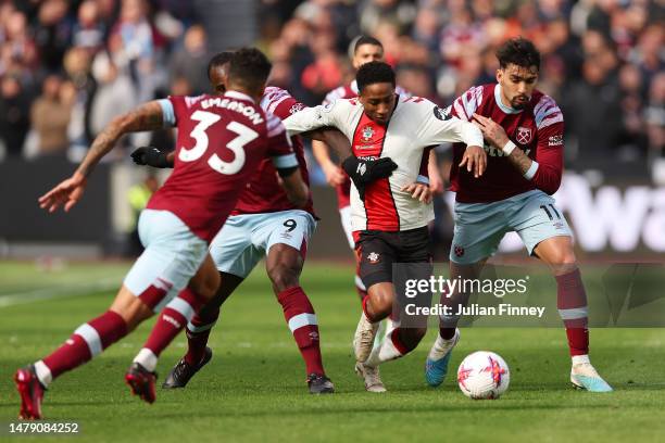 Kamaldeen Sulemana of Southampton battles for possession with Lucas Paqueta and Michail Antonio of West Ham United during the Premier League match...