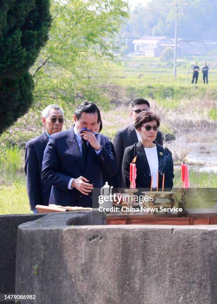 Ma Ying-jeou, former chairman of the Chinese Kuomintang party, and his sisters pay respects to their ancestors at the tomb of his grandfather on...