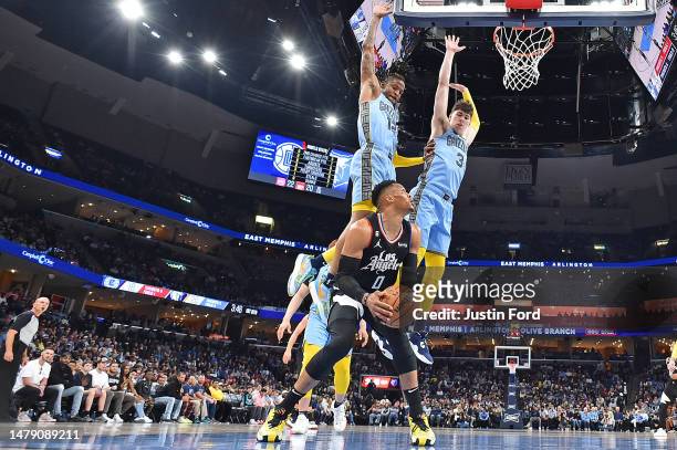 Russell Westbrook of the LA Clippers handles the ball against Ja Morant of the Memphis Grizzlies and Jake LaRavia of the Memphis Grizzlies during the...