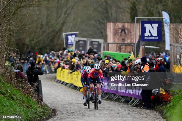 Lorena Wiebes of The Netherlands Pink UCI Women’s WorldTour Leader Jersey and Lotte Kopecky of Belgium and Team SD Worx compete passing through a...