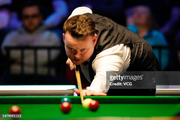 Shaun Murphy of England plays a shot in the semi-final match against Mark Selby of England on day six of Tour Championship Snooker 2023 at the Bonus...