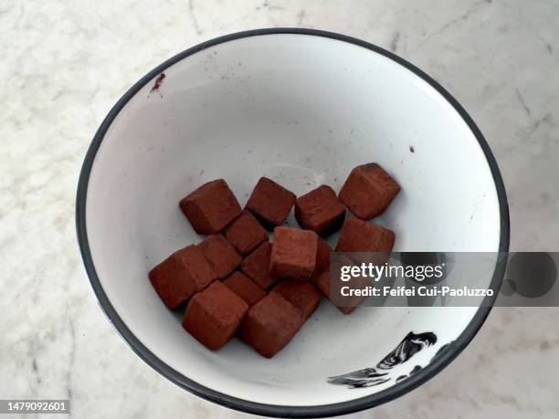 chocolate truffle in small cube shape in a bowl - chocolate cube stock pictures, royalty-free photos & images