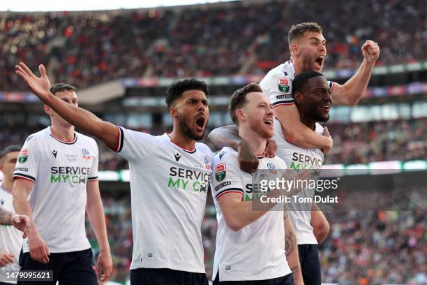 Gethin Jones of Bolton Wanderers celebrates with teammates after scoring the team's fourth goal during the Papa John's Trophy Final between Bolton...