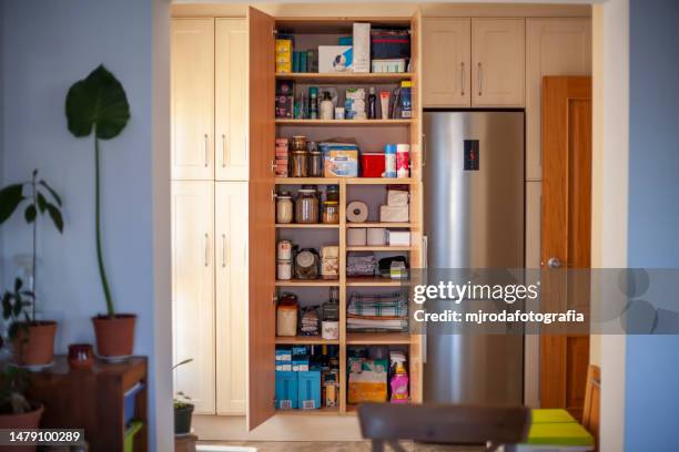 storage room with organised pantry items - voorraadkast stockfoto's en -beelden