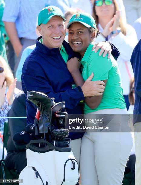 Maya Palanza Gaudin of The United States is congratulated by her father Steve Gaudin beside the 18th green as they realise that she has won the Girls...