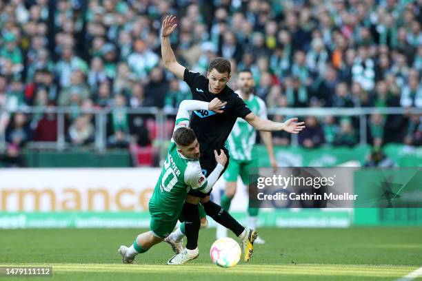 Romano Schmid of SV Werder Bremen challenges Dennis Geiger of TSG Hoffenheim during the Bundesliga match between SV Werder Bremen and TSG Hoffenheim...