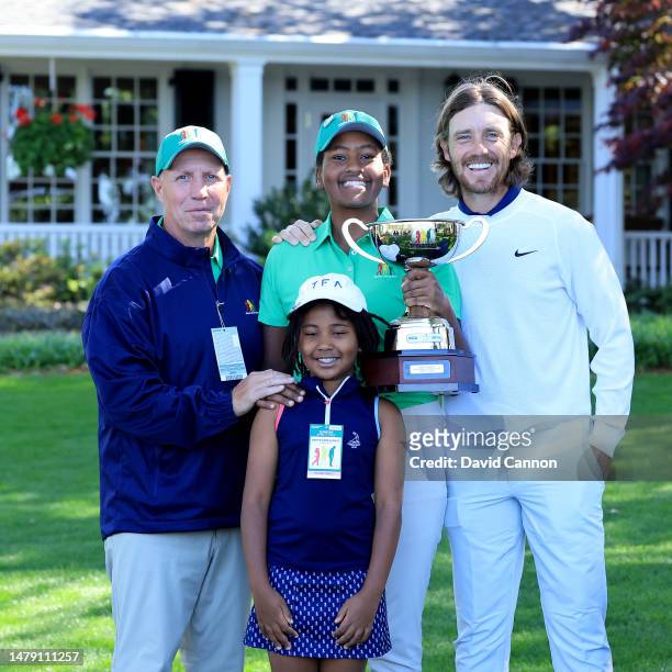 Maya Palanza Gaudin of The United States the Girls 12-13 year group overall champion poses with her trophy with her father Steve Gaudin, her sister...