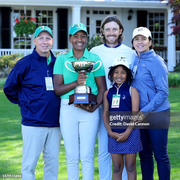 Maya Palanza Gaudin of The United States the Girls 12-13 year group overall champion poses with her trophy with her father Steve Gaudin, her mother...