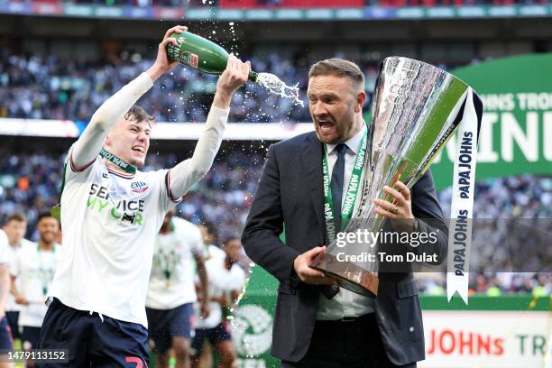 Conor Bradley of Bolton Wanderers celebrates with Ian Evatt, Manager of Bolton Wanderers, as he lifts the Papa John's Trophy following their victory...