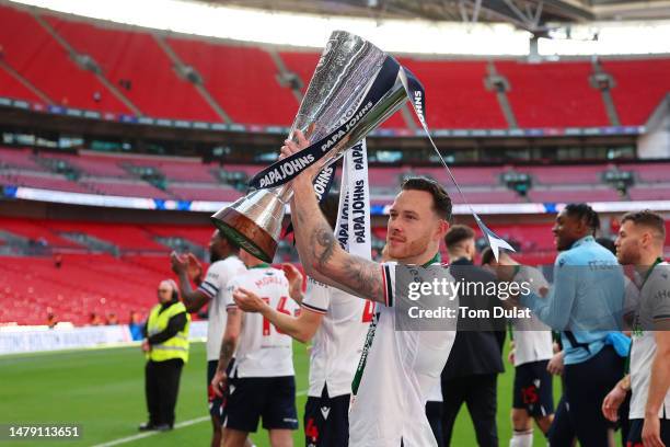 Gethin Jones of Bolton Wanderers lifts the Papa John's Trophy following their victory in the Papa John's Trophy Final between Bolton Wanderers and...