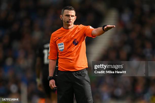 Referee Michael Oliver signals during the Premier League match between Brighton & Hove Albion and Brentford FC at American Express Community Stadium...