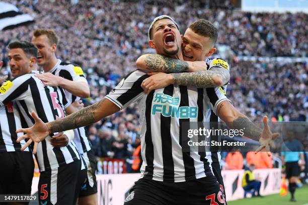 Bruno Guimaraes of Newcastle United celebrates with teammate Keiran Trippier after Joe Willock scores the teams first goal during the Premier League...