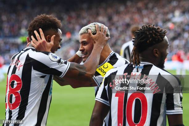 Joe Willock of Newcastle United celebrates with teammate Bruno Guimaraes after scoring the teams first goal during the Premier League match between...