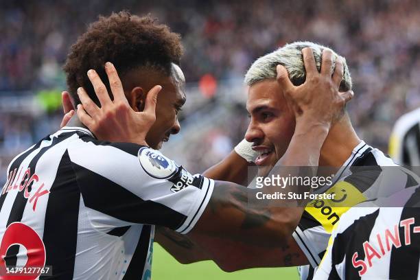 Joe Willock of Newcastle United celebrates with teammate Bruno Guimaraes after scoring the teams first goal during the Premier League match between...