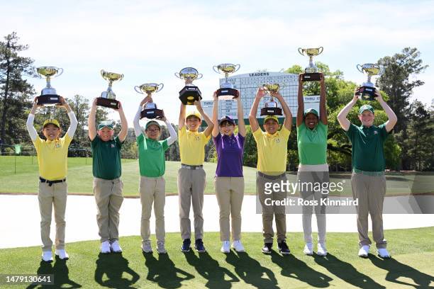 The overall first place winners pose with their trophies during the Drive, Chip and Putt Championship at Augusta National Golf Club at Augusta...