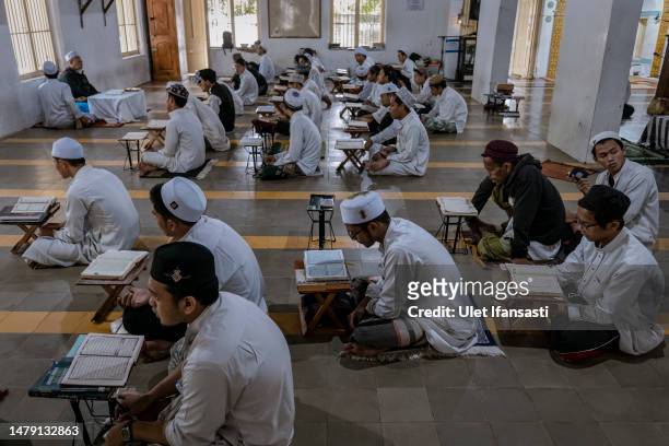 Students learn Islamic scriptures in the Islamic boarding school Al-Fatah Temboro during the holy month of Ramadan on April 02, 2023 in Magetan, East...