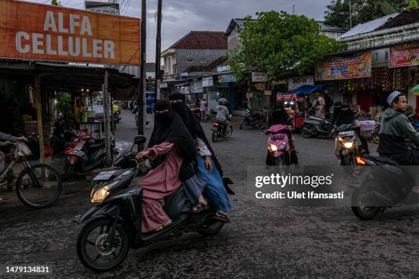 Women wearing niqab riding motorbikes at Temboro village during the holy month of Ramadan on April 02, 2023 in Magetan, East Java, Indonesia....