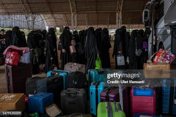 Female students are lining up to get on their bus to take them to their hometown to celebrate Eid al-Fitr at the Islamic boarding school Al-Fatah...