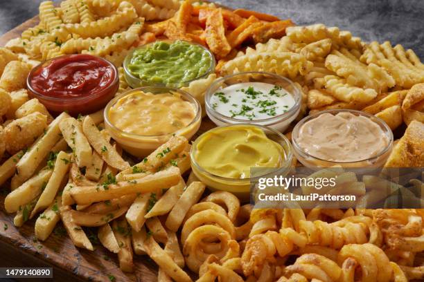 the ultimate french fry board - cheese sauce stock pictures, royalty-free photos & images