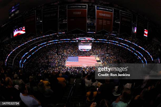 The American flag covers the court during the singing of the national anthem prior to the game between the LSU Lady Tigers and Iowa Hawkeyes during...