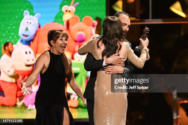Helen George presents the Best Family Show award to Vikki Stone and Matthew Xia for “Hey Duggee: The Live Theatre Show”onstage at The Olivier Awards...