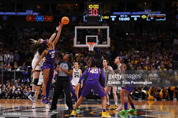Angel Reese of the LSU Lady Tigers and Monika Czinano of the Iowa Hawkeyes jump for the ball to start the game during the 2023 NCAA Women's...