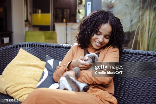 young african american woman with her cat - black hairy women bildbanksfoton och bilder