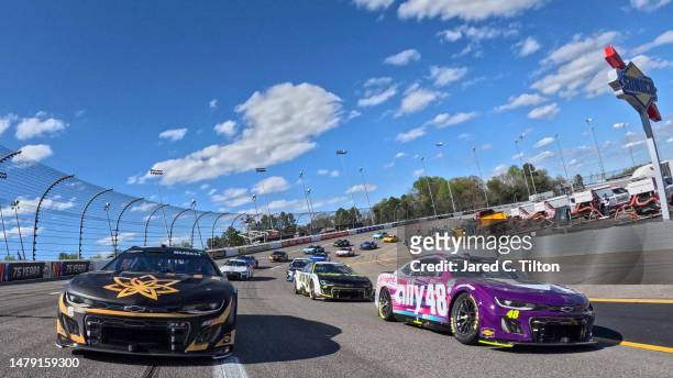 Kyle Busch, driver of the 3CHI Chevrolet, and Alex Bowman, driver of the Ally Chevrolet, lead the field on a pace lap prior to the NASCAR Cup Series...