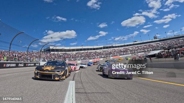Kyle Busch, driver of the 3CHI Chevrolet, and Alex Bowman, driver of the Ally Chevrolet, lead the field on a pace lap prior to the NASCAR Cup Series...