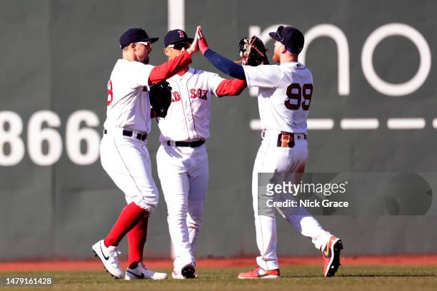The Boston Red Sox outfield celebrates a win after the game between the Boston Red Sox and the Baltimore Orioles at Fenway Park on April 02, 2023 in...