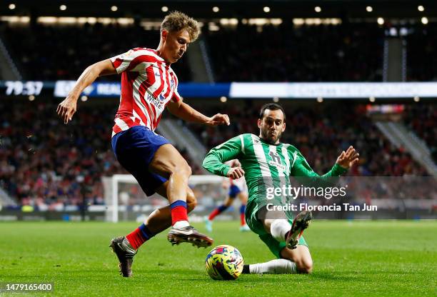 Marcos Llorente of Atletico Madrid battle for the ball with Juanmi of Real Betis during the LaLiga Santander match between Atletico de Madrid and...