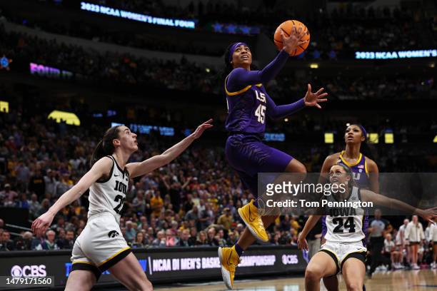 Alexis Morris of the LSU Lady Tigers drives to the basket against Caitlin Clark of the Iowa Hawkeyes during the third quarter during the 2023 NCAA...