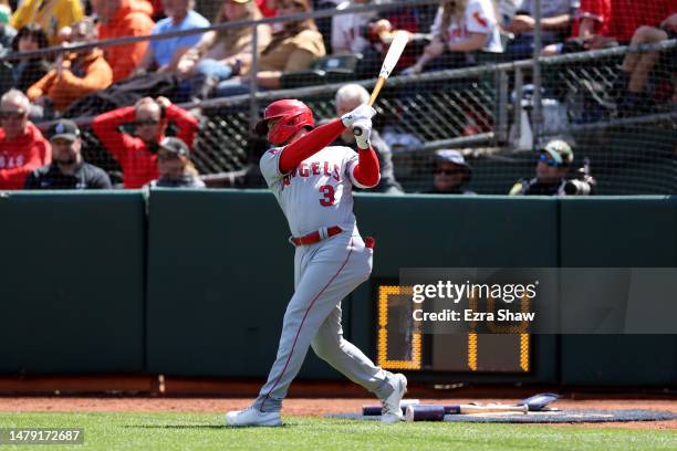 Taylor Ward of the Los Angeles Angels warms up in the on deck circle close to the pitches time clock during the third inning of their game against...