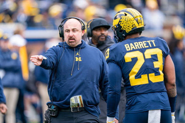 Linebackers Coach Chris Partridge speaks with Michael Barrett of the Blue Team during the second quarter of the Michigan Football spring game at...
