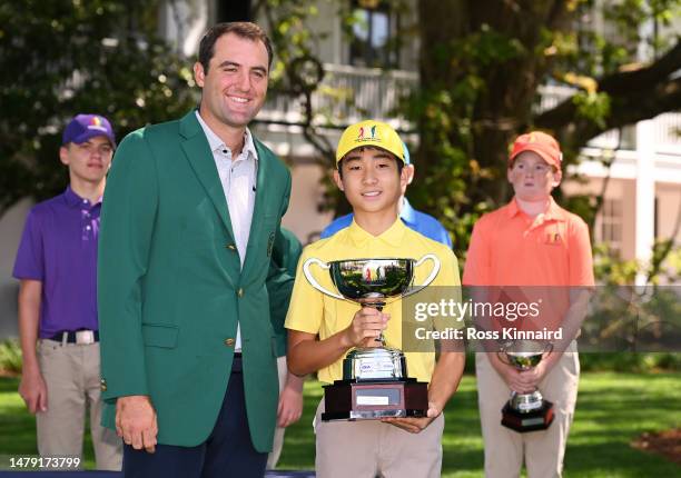 Scottie Scheffler of the United States poses with Leo Saito of the boys 12-13 group during the Drive, Chip and Putt Championship at Augusta National...