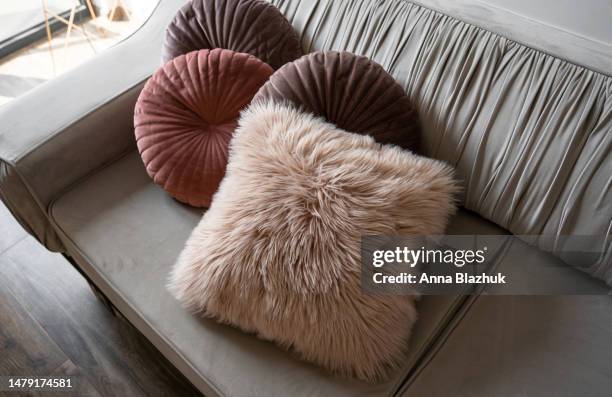 stylish colorful pink and grey cushions on couch in living room. home decor details. - cushion stock pictures, royalty-free photos & images