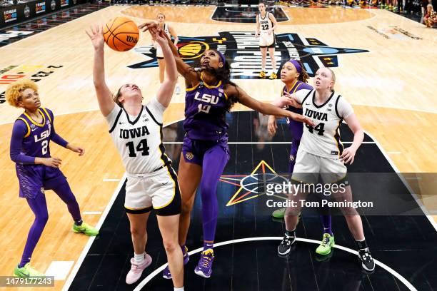 McKenna Warnock of the Iowa Hawkeyes and Angel Reese of the LSU Lady Tigers battle for the ball during the fourth quarter during the 2023 NCAA...