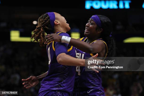 LaDazhia Williams and Flau'jae Johnson of the LSU Lady Tigers celebrate after defeating the Iowa Hawkeyes 102-85 during the 2023 NCAA Women's...