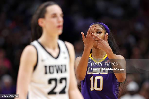 Angel Reese of the LSU Lady Tigers reacts towards Caitlin Clark of the Iowa Hawkeyes during the fourth quarter during the 2023 NCAA Women's...