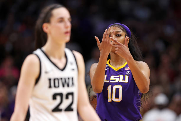 Angel Reese of the LSU Lady Tigers reacts towards Caitlin Clark of the Iowa Hawkeyes during the fourth quarter during the 2023 NCAA Women's...