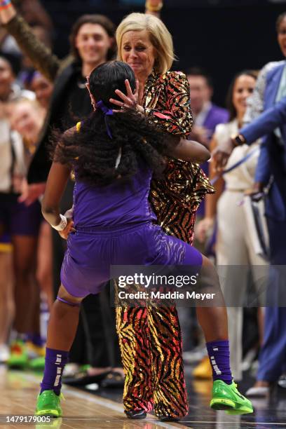 Head coach Kim Mulkey of the LSU Lady Tigers hugs a player after defeating the Iowa Hawkeyes 102-85 during the 2023 NCAA Women's Basketball...